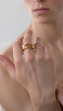 Load image into Gallery viewer, Close-up of a hand wearing a gold organic shaped ring on a neutral background
