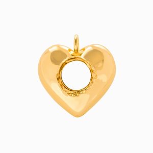 Gold pierced heart-shaped pendant on a white background